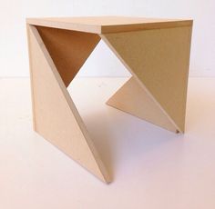 a small table made out of cardboard on a white surface