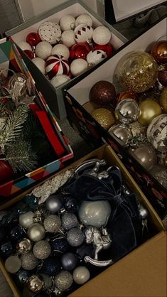 three boxes filled with assorted christmas ornaments