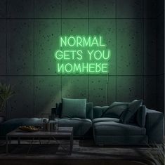 a neon sign that says normal gets you momhebe on the side of a wall