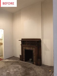 an empty room with a fireplace and no one in it