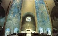 the inside of a church with painted walls and pews