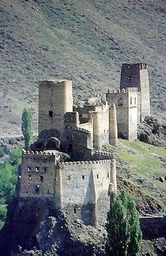 an old castle sitting on top of a hill