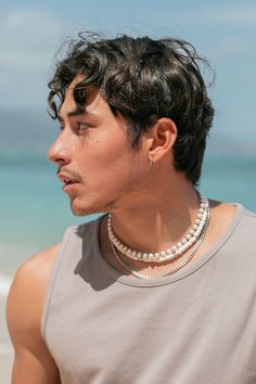 Classic white puka shell necklace with silver accents. Designed to be gender inclusive, this puka necklace is a beach staple. Choose your length for the perfect fit. Bryson is wearing the 16 Inch Length. ✦ Due to the nature of the puka shells, each necklace is one of a kind, therefore color, shape, and size will vary. ✦ ✦ DETAILS ✦ ✧ Name: Ikaika (ee-KIE-kah) - man of strength. ✧ 4-6mm Natural White Puka Shells. ✧ Sterling Silver Hook & Eye Clasp. ✧ Silver plated base metal accents. ✧ All Ke Alo Seashell Necklace Men, Puka Shell Necklace Men, Shell Necklace Men, Puka Necklace, Soft Boy Aesthetic, Classic Pearl Necklace, Puka Shell Necklace, Gender Inclusive, Surfer Necklace