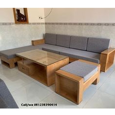 a couch and table in a room with white tile flooring on the wall behind it