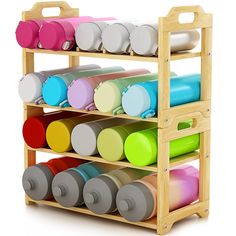 a wooden rack filled with lots of different colored cups