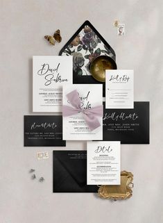 the wedding stationery is laid out on top of each other, including an envelope with a bow