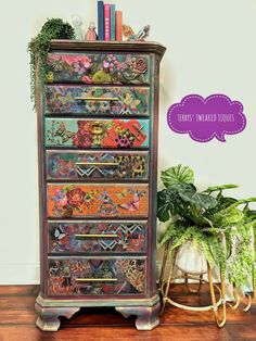 an old dresser is painted with colorful flowers