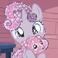 a little pony holding a stuffed animal in her lap with sparkles on it's face