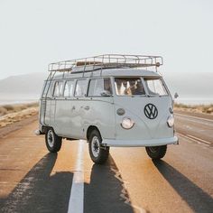 an old vw bus driving down the road