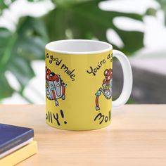 a yellow coffee mug sitting on top of a wooden table