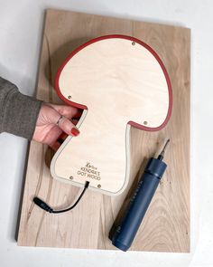 a person is working on a wooden object with wires attached to the back of it