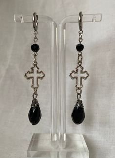 "☆ Stainless steel hug hoop clasp earrings 10mm. Cross charms and black drop beads. ☆ 3\" length" Nickel Free Black Hoop Earrings Gift, Black Drop Jewelry With Pierced Details, Hypoallergenic Black Metal Jewelry, Nickel Free Black Long Drop Earrings, Black Long Drop Pierced Jewelry, Black Metal Drop Earrings, Black Long Drop Earrings With Ear Wire, Black Teardrop Jewelry With Ear Wire, Black Dangle Earrings With Ear Wire