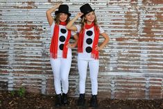 two girls dressed in costumes standing next to each other