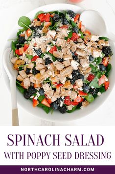 spinach salad with poppy seed dressing in a white bowl