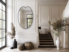 a large mirror on the wall above a stair case next to a potted plant