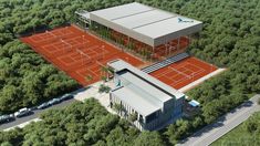 an aerial view of a tennis court surrounded by trees