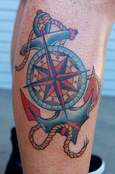 an anchor, compass and rope tattoo on the leg