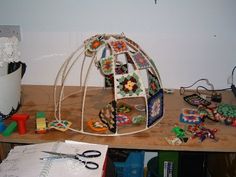 a wooden table topped with lots of crafting supplies and paper work on top of it