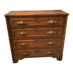 an antique chest of drawers with carved handles and knobs on the front, in walnut wood