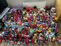 a pile of littlest pet toys sitting on the floor