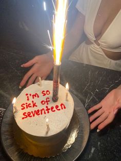 a birthday cake with lit candles in the middle and i'm so sick of seventeen written on it