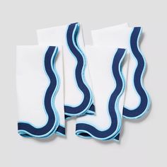 three pairs of white and blue socks with wavy lines on them, sitting next to each other