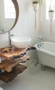 a bathroom with a sink, mirror and bathtub next to a window in it