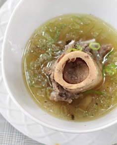 a white bowl filled with soup on top of a table