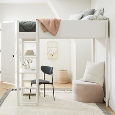 a white loft bed sitting next to a desk with a chair on top of it