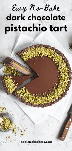 an easy no - bake dark chocolate pistachio tart is ready to be eaten