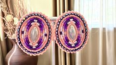 Beaded pink and purple earrings. Pink, purple, white, beads surrounding a oval pearl shaped gem. Rhinestone banding Purple Beaded Earrings, Chino Hills, Native American Beaded Earrings, Wrap Earrings, Native Style, Purple Earrings, Native American Beading, Earrings Pink, White Beads