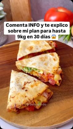 two quesadillas sitting on top of a wooden cutting board next to tomatoes