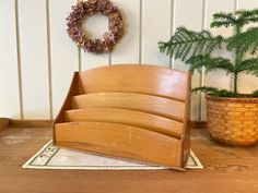 a set of five wooden utensils sitting on top of a table next to a potted plant