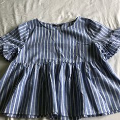 Blue And White Striped. Short Sleeve. Ruffles On Sleeves. Never Worn Cute Fitted Blue Blouse, Cute Blue Tops For The Beach, Cute Blue Summer Blouse, Blue Ruffled Beach Blouse, Blue Ruffled Blouse For Beach, Cute Blue Blouse For Spring, Cute Blue Spring Blouse, Sleeve Ruffles, Striped Short