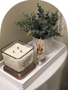 a candle sitting on top of a white counter