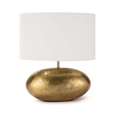 a gold table lamp with a white shade