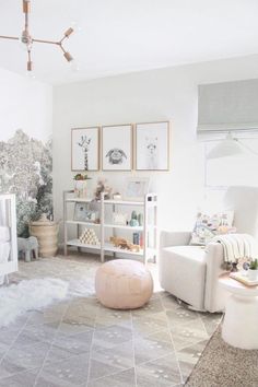 a baby's room with white furniture and pictures on the wall