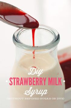 homemade strawberry milk in a glass jar with a spoon pouring it into the bottle and text overlay reads diy strawberry milk syrup without refated sugar or dry