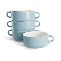 four blue mugs stacked on top of each other