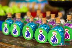 small bottles filled with colorful candies on top of a table