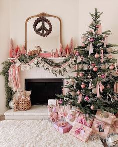 a decorated christmas tree in front of a fireplace