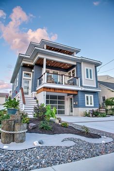 a large blue house sitting on the side of a road