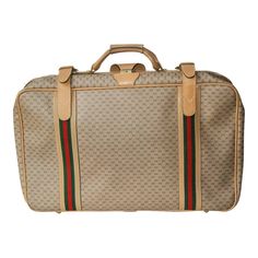 Circa 1970 Travel in high style with this superbly crafted Gucci suitcase. The interior includes Gucci monogrammed clothing tie-downs and the brass Gucci nameplate and embossed leather serial number. The exterior includes the impressed signature to the brass hardware and the classic Gucci red and green striped fabric. The suitcase includes a certificate of authentication from Authenticate First. Gucci Suitcase, Gucci Decor, Monogram Outfit, Trunks And Chests, Gucci Purses, Fabric Logo, Gucci Monogram, Gucci Leather, Luggage Accessories