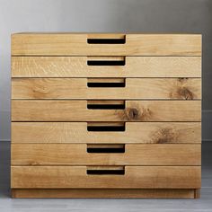 a wooden dresser with five drawers on it