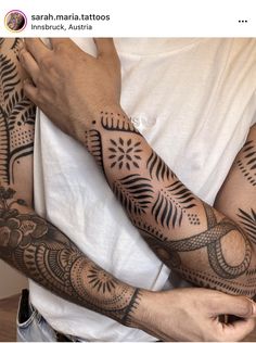 two men with matching tattoos on their arms