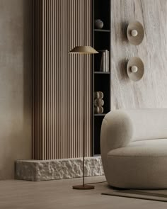 a living room with a couch, lamp and bookshelf on the wall behind it