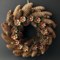 a pine cone wreath hanging on a wall