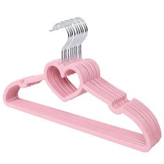 a pink plastic hanger with two heart shaped clips attached to the top of it