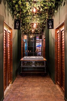 the hallway is decorated with greenery and wooden shutters