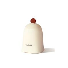 a small white bell with a red knob on top